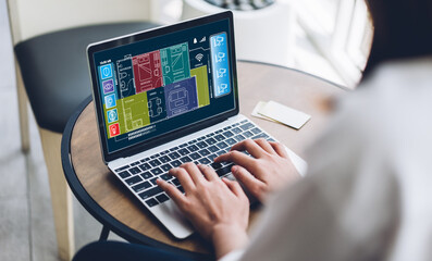 Person using and convenience a laptop to control a smart home system screen displays various smart home icons and functions, technology in modern living, smart technology into everyday life at home