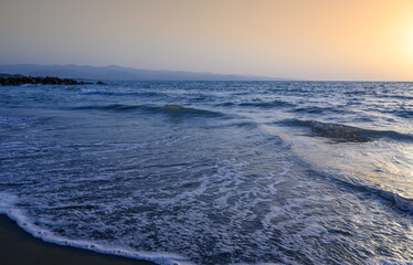 Splendid summer sunset with cloudy sky at rocky Cypriot coast