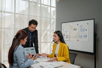 Financial teamwork with Marketing and Accounting Business professionals working together at office desk, hands close up pointing out financial data on a report negotiation, Analysis, Discussion