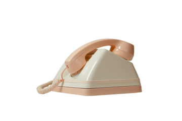 Vintage beige rotary telephone with cord on white background, capturing nostalgic retro communication technology from a bygone era.