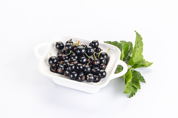 Juicy black currant berries in the bowl
