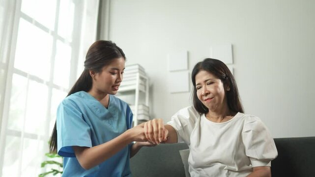 Caregiver helps patient with physical therapy exercises for upper limb mobility and strength in a bright, comfortable setting