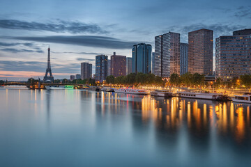 Fototapeta premium Paris cityscape on the Seine river with the Eiffel tower in the background taken at dawn, Paris, France