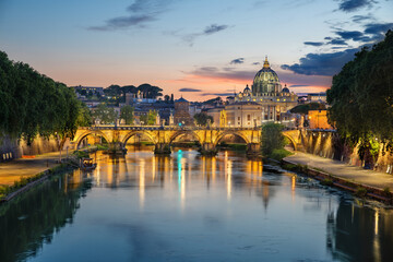 St.Peters Basilica and Sant'angelo bridge taken at sunset over the Tiber river, Rome, Italy