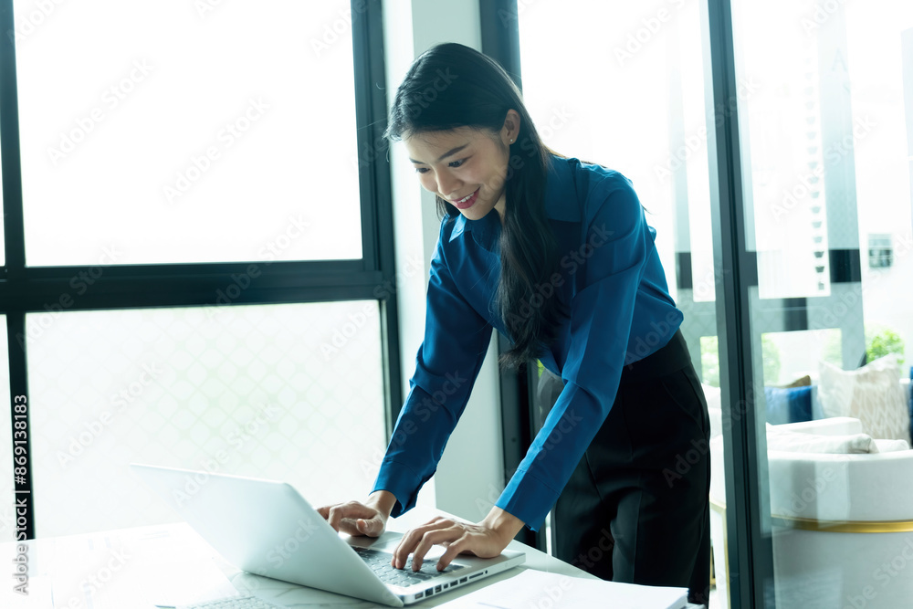 Wall mural woman is working on laptop.