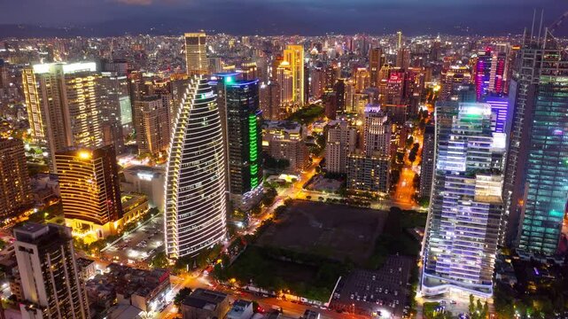 Aerial skyline of Downtown Taichung, a vibrant metropolis in central Taiwan, with modern high-rise office towers booming in the 7th Redevelopment Zone and city lights dazzling at night (in hyperlapse)