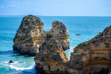 View of idyllic nature landscape with rocky cliff shore and waves crashing on. Camillo beach in Lagos. West Atlantic coast of Algarve region, south of Portugal.