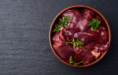 Raw chicken giblets liver, meat background.