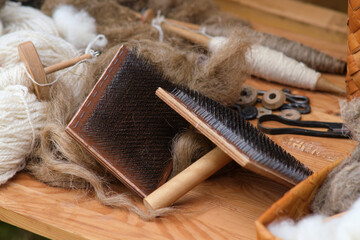 The skill of carding wool by hand, is crucial for producing quality yarn.