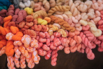 Skeins of wool hang on a rope ready for the sewing and needlework process