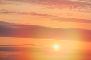 Sunset sky with orange clouds in the evening. Natural background.