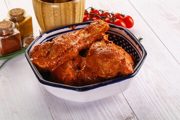 Raw turkey shoulder wing in Indian tandoori marinade