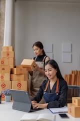 Small Business Startup, SME Owner, Two Asian Female Entrepreneurs check product inventory, stock, packing, order management. SME online business ideas, delivery ideas.