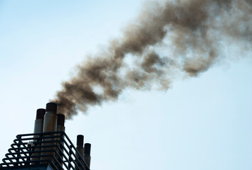 Smoke stack on ship emitting poisonous gas under sky