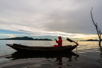 beautiful muslim woman praying outdoors at sunset