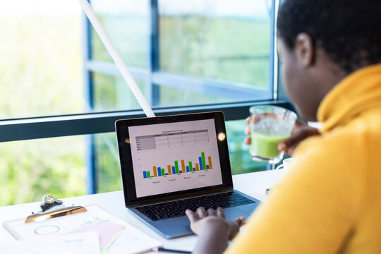 Businesswoman preparing statistics on laptop at office