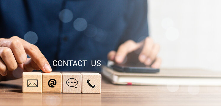 Website page contact us or e-mail marketing concept, Customer support hotline Contact us people connection. banner with copy space. cube wood with email, call phone, address, Chat message icons.