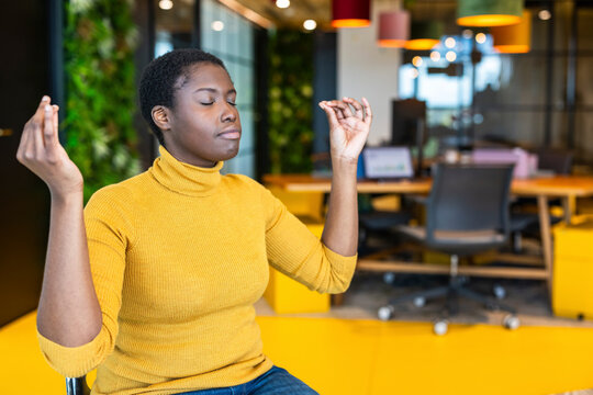 Businesswoman meditating at coworking space