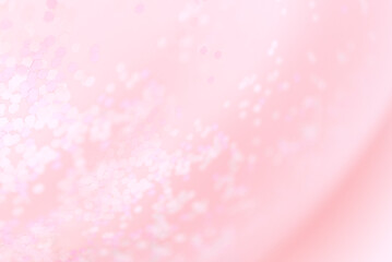 Pink blurred background with glitter confetti, pastel rose pink color