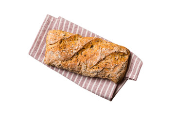 Freshly baked delicious french bread with napkin isolated on white background top view. Healthy white bread loaf