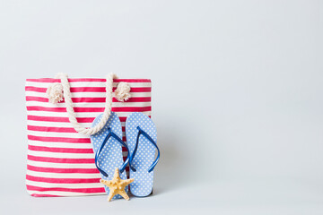 Stylish bag with beach accessories . Summer holiday concept. beach bag with straw hat with space for text