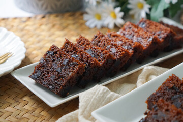 Kek Buah Kukus, a traditional Malaysian steamed fruit cake filled with dried fruits, nuts, and spices, enjoyed during celebrations.