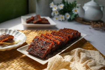 Kek Buah Kukus, a traditional Malaysian steamed fruit cake filled with dried fruits, nuts, and spices, enjoyed during celebrations.
