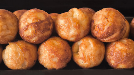 Takoyaki snacks on a black tray, Japanese style food