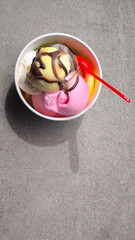 Popsicles in paper cups and red spoons