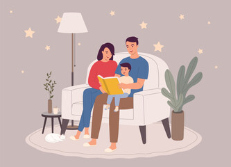 Smiling Parents Sitting On Couch Reading A Bedtime Story Together With Their Little Son During Night Time.
