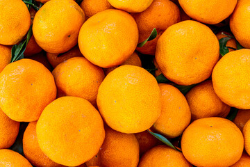 orange mandarin background of fresh juicy tangerines close up, vegan friut conception of citrus