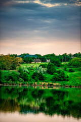 Sunset over the river . Another river beach. May and trees . Green colors . Reflections on water . Fising on river . Golden sunset 