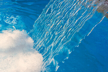Jets of water in a swimming pool on a sunny day. Charcot shower. Water massage.