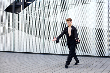 Professional male dancer in a black suit dances ballroom choreography