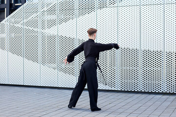 Athletic male dancer conducting a ballroom dance class