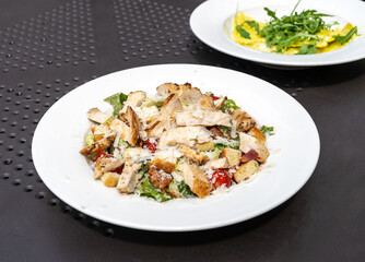 Caesar Salad, Green Lettuce Salat with Chicken and Parmesan Cheese Closeup