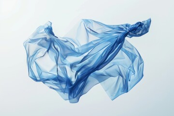 Fototapeta premium A piece of blue fabric floats gently through the air, caught in a moment of motion