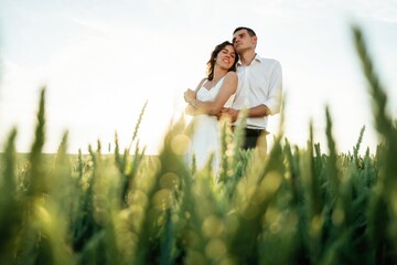 High wheat. Lovely couple are on the agricultural field together