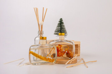 Diffuser bottles with sticks and stylish props isolated on white background 