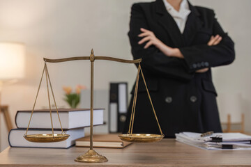 Confident Young Lawyer Standing in Modern Office with Scales of Justice and Legal Documents on Desk