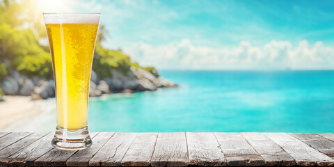 Glass of beer on a table with a stunning sea and beach background