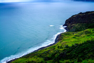 Panoramic view over Te Toto Gorge and Tasman Sea on an overcast summer day. High vantage point. Raglan, New Zealand