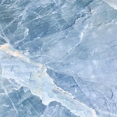 Obraz premium A highly detailed close-up photograph of blue toned marble rock with intricate veining and visible texture, showcasing the natural beauty and patterns of the stone.