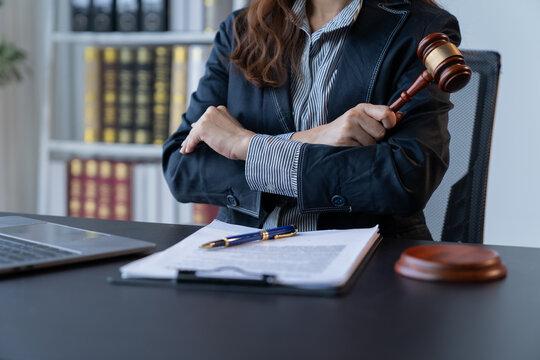 A female attorney is diligently working at her desk in the office.