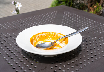 Food remains in plate, red leftovers, smeared sauce after lunch or dinner. Empty dirty plates, food waste