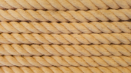 Thick ropes of light golden brown color arranged in rows, realistic ceramic lighting, with rounded braid binding. Raw, wrapping 3D models. Free space for text. close up, micro patterned texture © Talcoco photoart