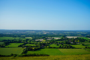 View of green farm fields and blue sky in the South of England