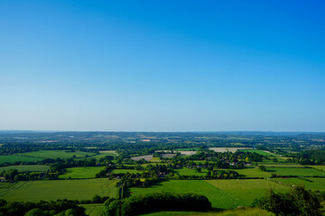 Obraz premium View of green farm fields and blue sky in the South of England