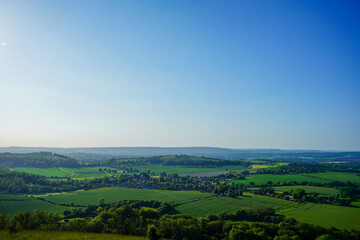 View of green farm fields and blue sky in the South of England