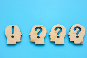 Mentoring and coaching concept. Heads with question marks and one with an exclamation mark.